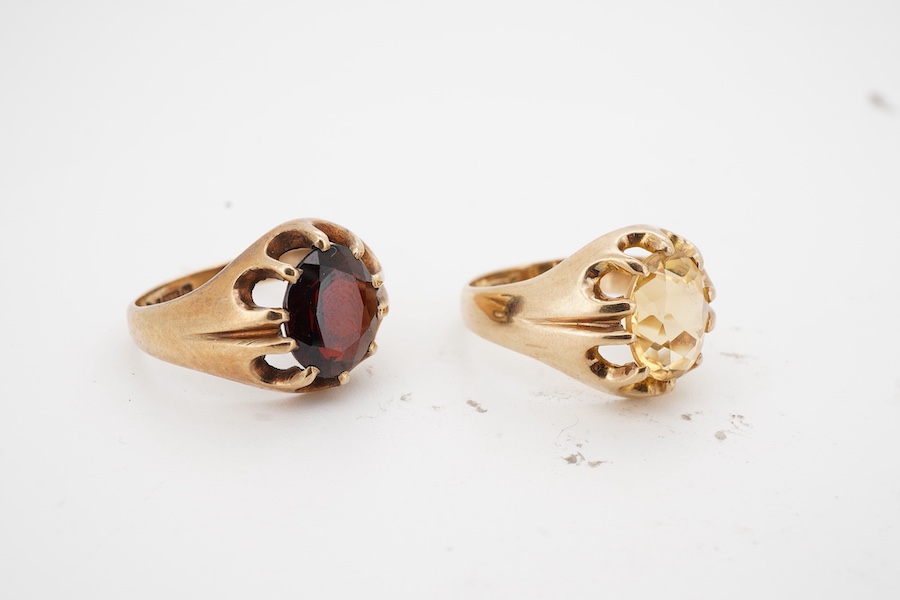Two gem-set rings, early 20th century, one set with an oval citrine, the other with an oval garnet, each mounted in 9ct gold, sizes M1/2 and N respectively, each with British hallmark, combined gross weight approximately